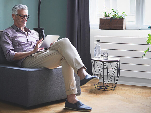 Mature man using tablet at home