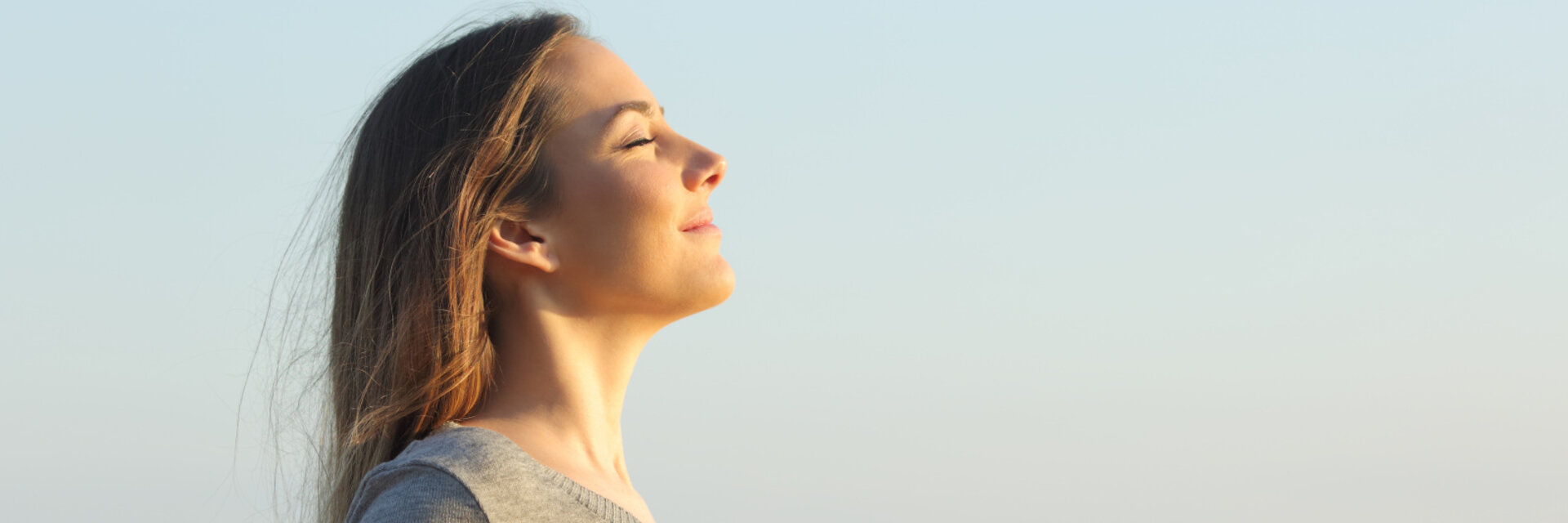 Side view portrait of a relaxed woman breathing fresh air on the beach