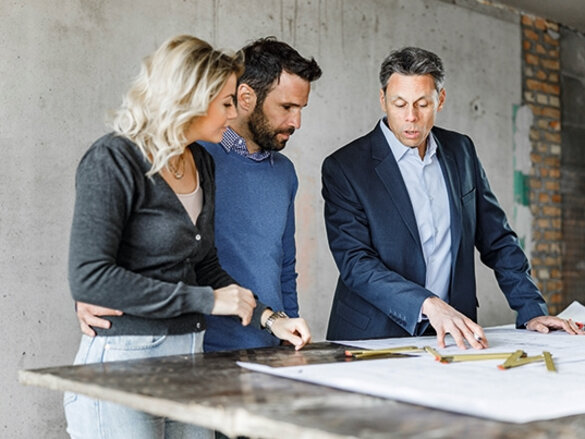 two men and one women are talking about plans, trusted partner