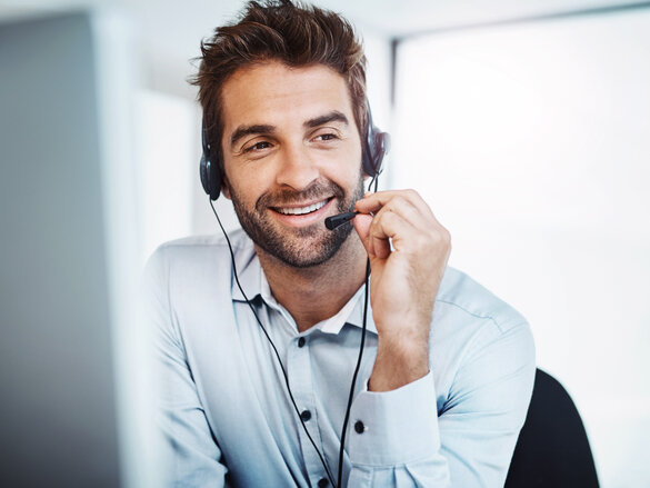 young, call centre agent, working in an office. guy on phone,