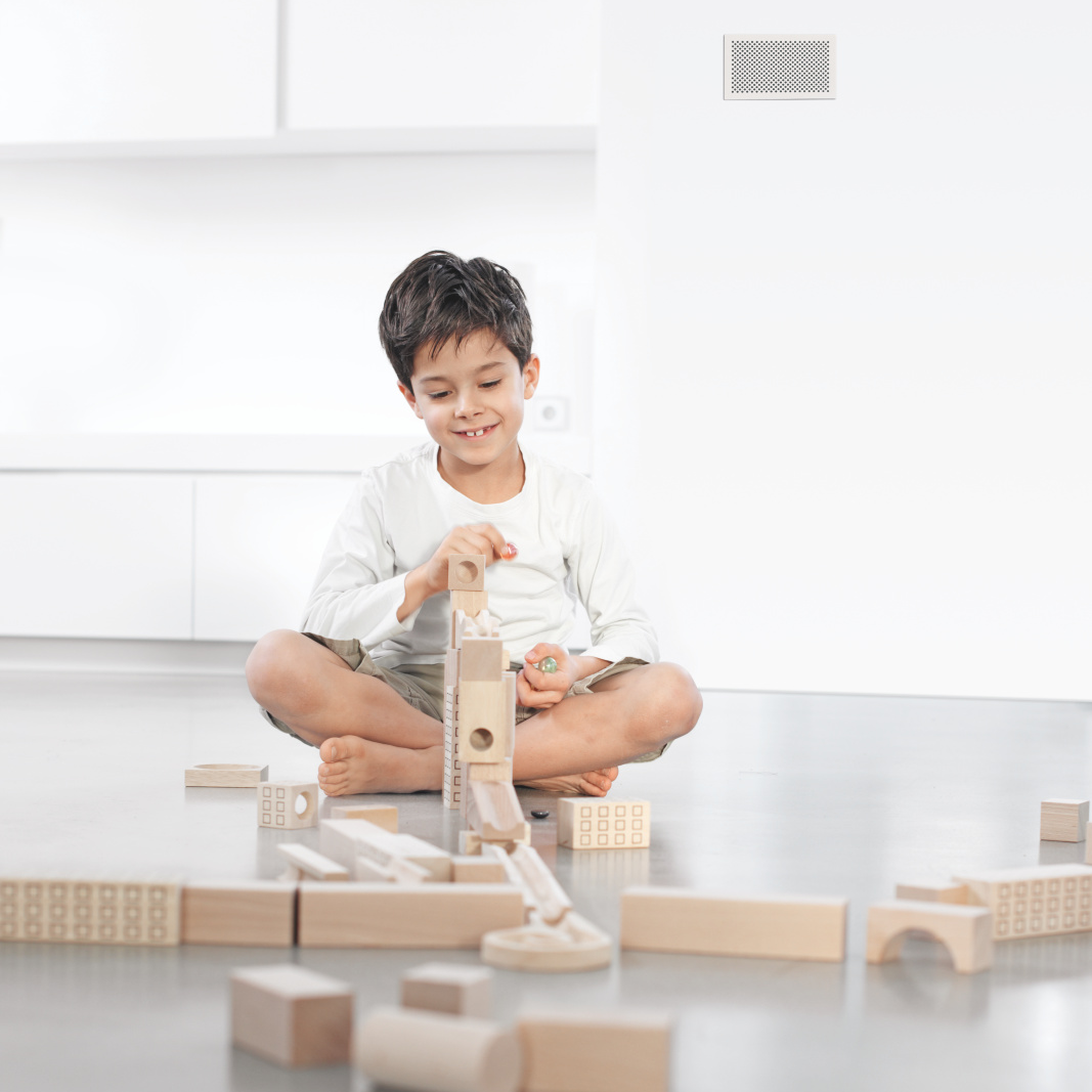 L'enfant joue. Grille de recouvrement pour l'air pulsé