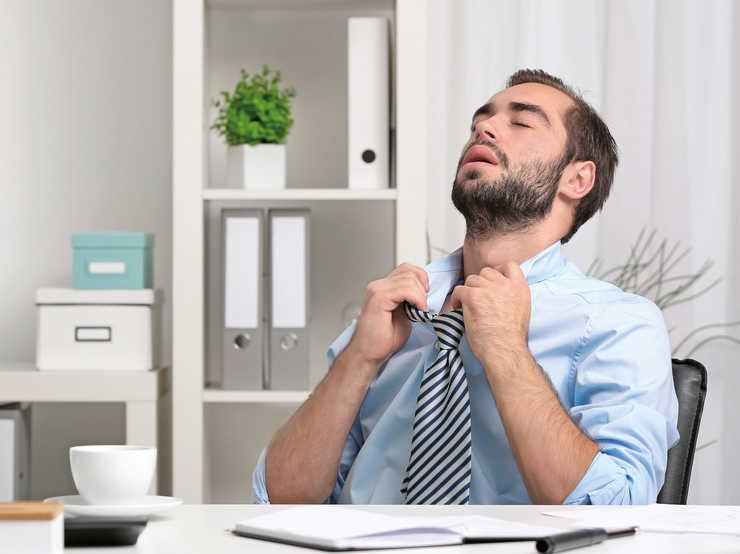 Mauvaise qualité de l'air intérieur Un homme ouvre le col de sa chemise